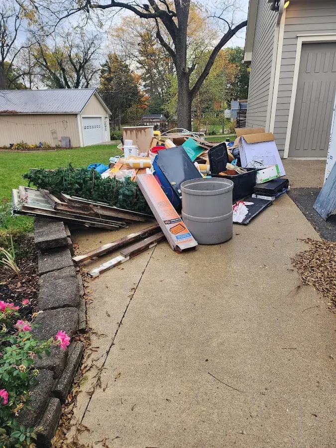 Dumpster being loaded with debris for 3 Yard Dumpster Rental in Providence Village